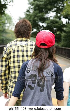 Rear view of a man and a woman in a park View Large Photo Image Stock Photo - Rear view of a man and a woman in a park. Fotosearch