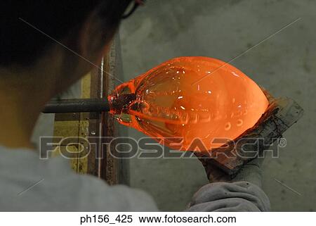 Rear view of a man holding molten glass View Large Photo Image Stock Photography - Rear view of a man holding molten glass. Fotosearch