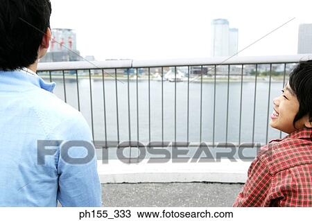 Rear view of a mid adult man and his son View Large Photo Image Stock Image - Rear view of a mid adult man and his son. Fotosearch
