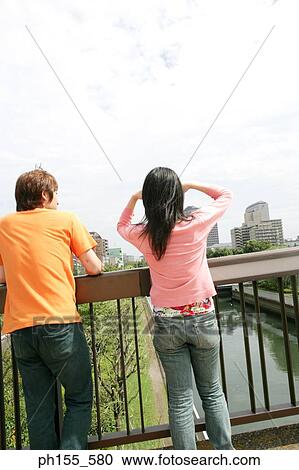 Rear view of a young couple View Large Photo Image Stock Image - Rear view of a young couple. Fotosearch