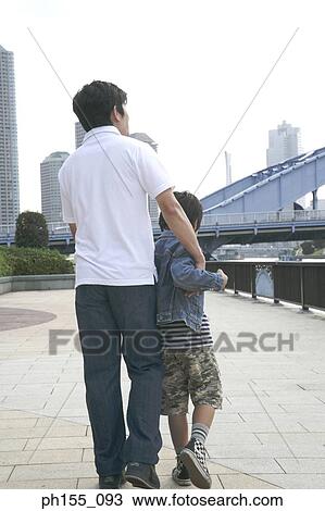 Rear view of a young man and his son View Large Photo Image Stock Image - Rear view of a young man and his son. Fotosearch