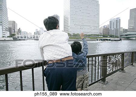 Rear view of a young man and his son View Large Photo Image Stock Photo - Rear view of a young man and his son. Fotosearch