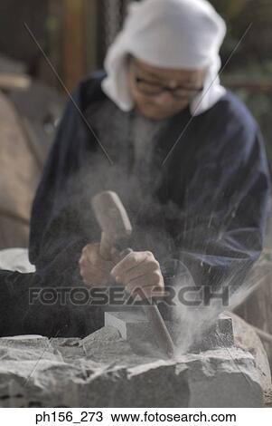 Sculptor carving a stone with a chisel and a hammer View Large Photo Image Stock Image - Sculptor carving a stone with a chisel and a hammer. Fotosearch