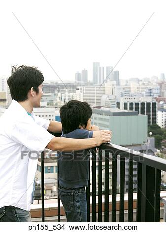 Side profile of a boy and his father looking away View Large Photo Image Picture - Side profile of a boy and his father looking away. Fotosearch