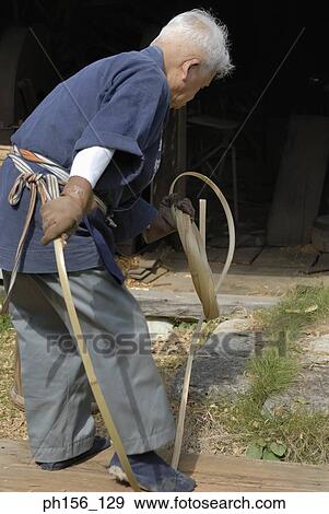 Stock Photo - Side profile of a carpenter twisting cane. Fotosearch