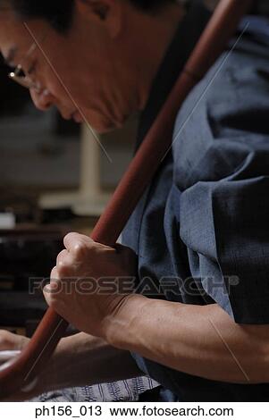 Side profile of a carpenter working on a wooden stick View Large Photo Image Stock Image - Side profile of a carpenter working on a wooden stick. Fotosearch