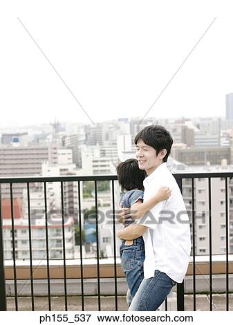 Side profile of a father embracing his son View Large Photo Image Stock Photo - Side profile of a father embracing his son. Fotosearch