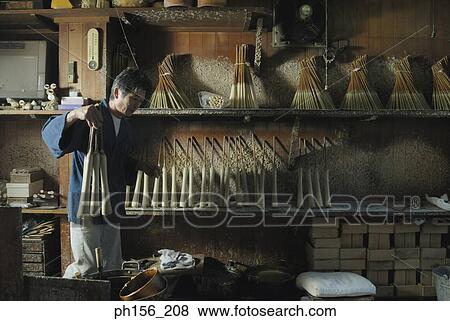 Stock Photo - Side profile of a man holding candles. Fotosearch
