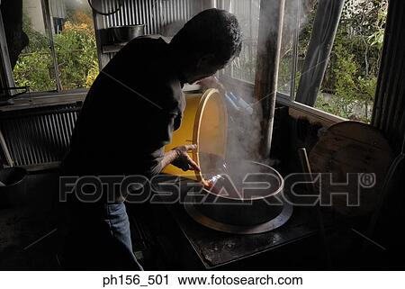Side profile of a man pouring dye in a container View Large Photo Image Stock Image - Side profile of a man pouring dye in a container. Fotosearch
