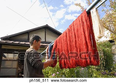 Side profile of a mature man drying silk threads on a pole View Large Photo Image Stock Image - Side profile of a mature man drying silk threads on a pole. Fotosearch