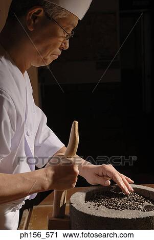 Side profile of a mature man grinding grain in a grinding stone View Large Photo Image Stock Image - Side profile of a mature man grinding grain in a grinding stone. Fotosearch