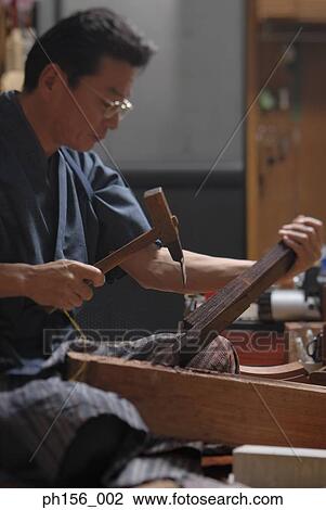 Side profile of a mature man hammering wood View Large Photo Image Stock Image - Side profile of a mature man hammering wood. Fotosearch