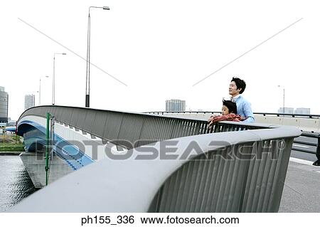 Side profile of a mid adult man holding his son from behind View Large Photo Image Stock Photograph - Side profile of a mid adult man holding his son from behind. Fotosearch