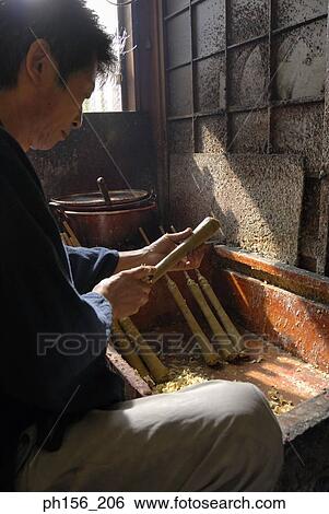 Side profile of a mid adult man making a candle View Large Photo Image Stock Photograph - Side profile of a mid adult man making a candle. Fotosearch