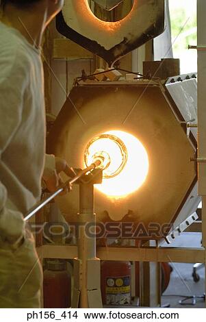 Side profile of a mid adult man molding a glass bulb View Large Photo Image Picture - Side profile of a mid adult man molding a glass bulb. Fotosearch