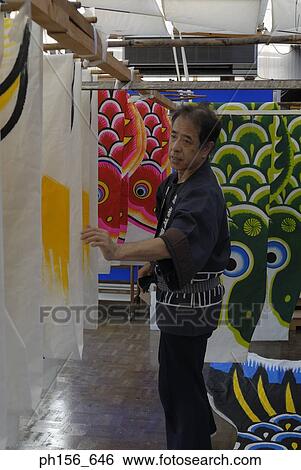 Side profile of a mid adult man arranging painted sheets in a workshop View Large Photo Image Stock Photograph - Side profile of a mid adult man arranging painted sheets in a workshop. Fotosearch
