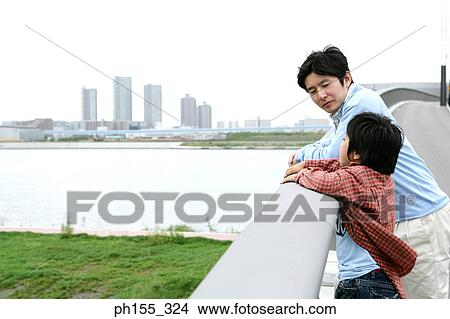 Side profile of a mid adult man talking to his son View Large Photo Image Picture - Side profile of a mid adult man talking to his son. Fotosearch