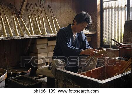 Stock Photo - Side profile of a person shaping a candle. Fotosearch
