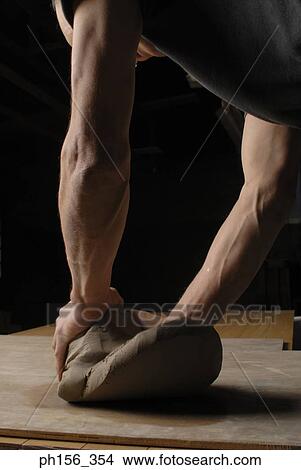 Side profile of a potter kneading clay View Large Photo Image Picture - Side profile of a potter kneading clay. Fotosearch