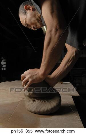 Stock Photography - Side profile of a potter kneading clay. Fotosearch