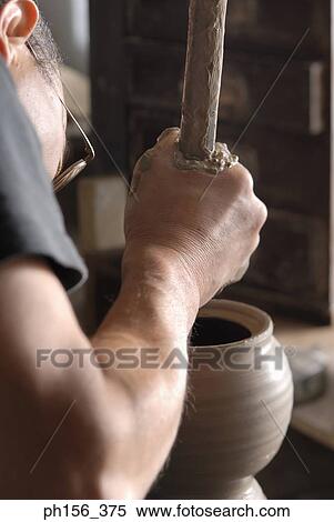 Side profile of a potter making a pot View Large Photo Image Stock Photography - Side profile of a potter making a pot. Fotosearch