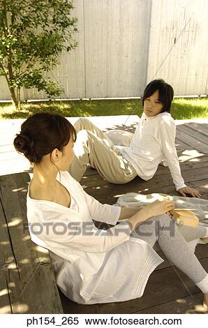 Side profile of a young couple looking at each other View Large Photo Image Stock Photography - Side profile of a young couple looking at each other. Fotosearch