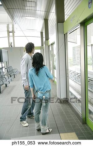 Side profile of a young couple standing at a subway station View Large Photo Image Stock Image - Side profile of a young couple standing at a subway station. Fotosearch