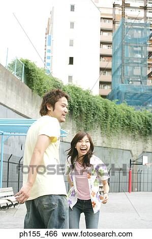 Side profile of a young man and a young woman laughing View Large Photo Image Stock Photograph - Side profile of a young man and a young woman laughing. Fotosearch