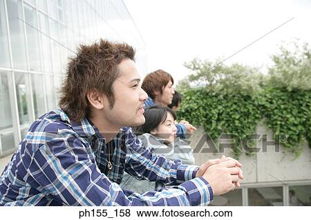 Side profile of a young man and his friends View Large Photo Image Stock Photo - Side profile of a young man and his friends. Fotosearch