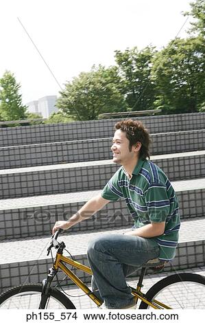 Side profile of a young man cycling View Large Photo Image Picture - Side profile of a young man cycling. Fotosearch