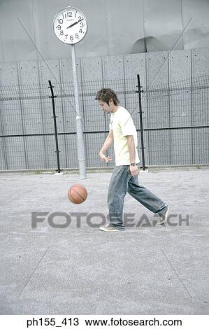 Side profile of a young man playing basketball View Large Photo Image Stock Image - Side profile of a young man playing basketball. Fotosearch