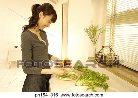 Side profile of a young woman looking at vegetables and smiling View Large Photo Image Stock Photograph - Side profile of a young woman looking at vegetables and smiling. Fotosearch
