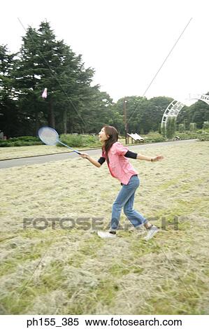 Side profile of a young woman playing badminton View Large Photo Image Stock Photography - Side profile of a young woman playing badminton. Fotosearch