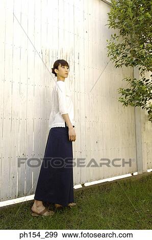 Side profile of a young woman standing View Large Photo Image Stock Photo - Side profile of a young woman standing. Fotosearch