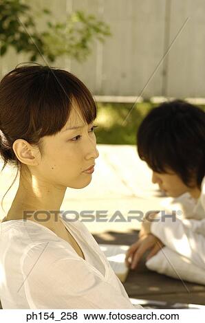 Side profile of a young woman with a young man View Large Photo Image Stock Photo - Side profile of a young woman with a young man. Fotosearch