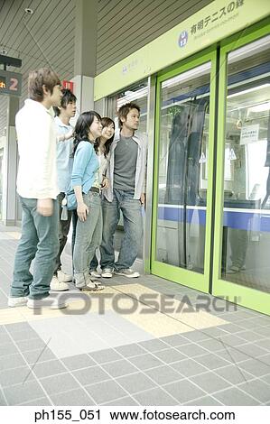 Side profile of five people standing at a subway station View Large Photo Image Stock Image - Side profile of five people standing at a subway station. Fotosearch