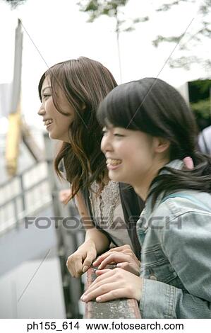 Side profile of two young women smiling View Large Photo Image Picture - Side profile of two young women smiling. Fotosearch