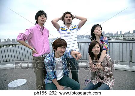 Three young men and two young women on a bridge View Large Photo Image Stock Image - Three young men and two young women on a bridge. Fotosearch