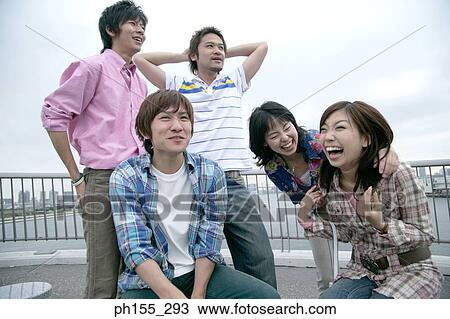 Three young men and two young women smiling View Large Photo Image Stock Image - Three young men and two young women smiling. Fotosearch