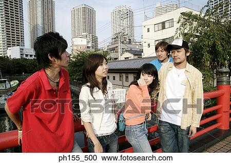 Three young men and two young women near a railing View Large Photo Image Stock Image - Three young men and two young women near a railing. Fotosearch