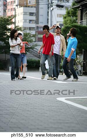 Three young men and two young women walking View Large Photo Image Stock Image - Three young men and two young women walking. Fotosearch