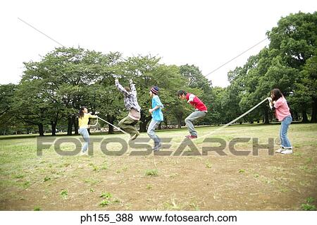 Stock Photo - Three young men and two young women playing jump rope. Fotosearch