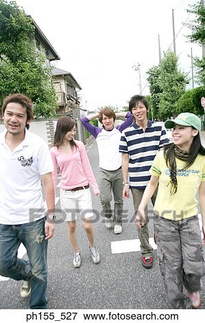 Three young men and two young women walking View Large Photo Image Stock Photo - Three young men and two young women walking. Fotosearch