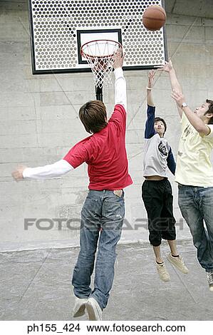 Picture - Three young men playing basketball. Fotosearch