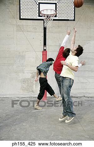 Three young men playing basketball View Large Photo Image Stock Photography - Three young men playing basketball. Fotosearch