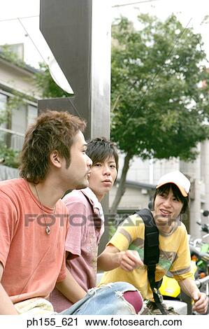 Three young men talking View Large Photo Image Stock Image - Three young men talking. Fotosearch