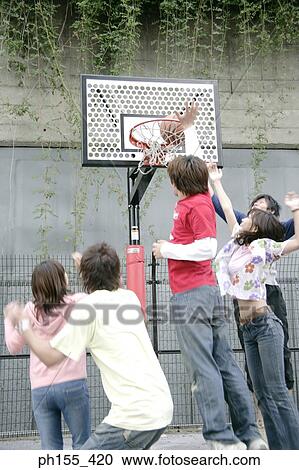 Three young men with two young women playing basketball View Large Photo Image Stock Image - Three young men with two young women playing basketball. Fotosearch