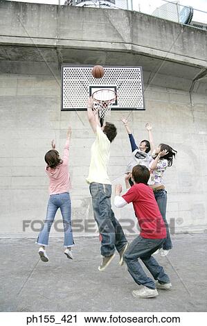 Three young men with two young women playing basketball View Large Photo Image Stock Image - Three young men with two young women playing basketball. Fotosearch