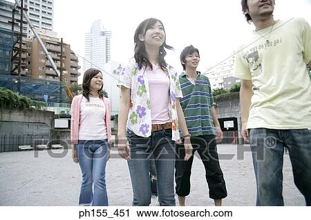 Two young men and two young women standing View Large Photo Image Stock Image - Two young men and two young women standing. Fotosearch