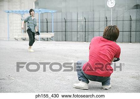 Two young men playing baseball View Large Photo Image Stock Image - Two young men playing baseball. Fotosearch